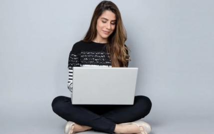 Woman sitting on the floor using a computer